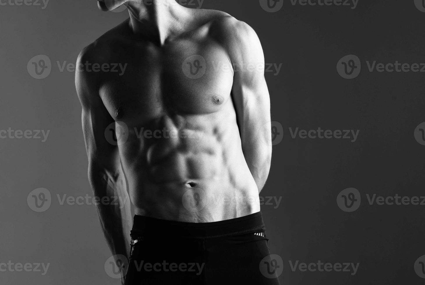 a man with a pumped up press workout with dumbbells exercises dark background photo