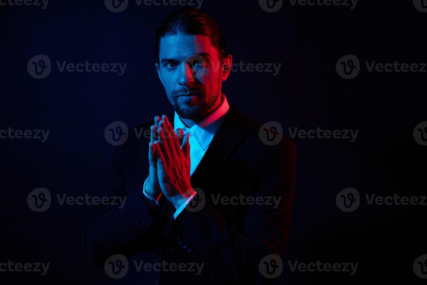 businessmen in a jacket posing self confidence dark background photo