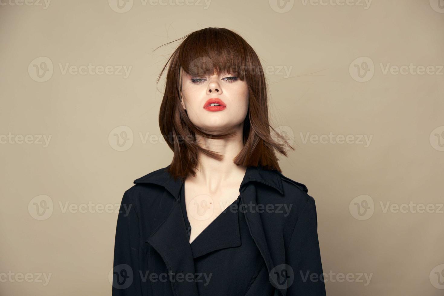 Funny woman black coat smile smiling on a beige background photo