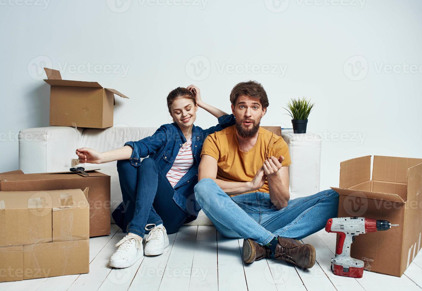 Man and woman with empty boxes Moving to an apartment indoor interior