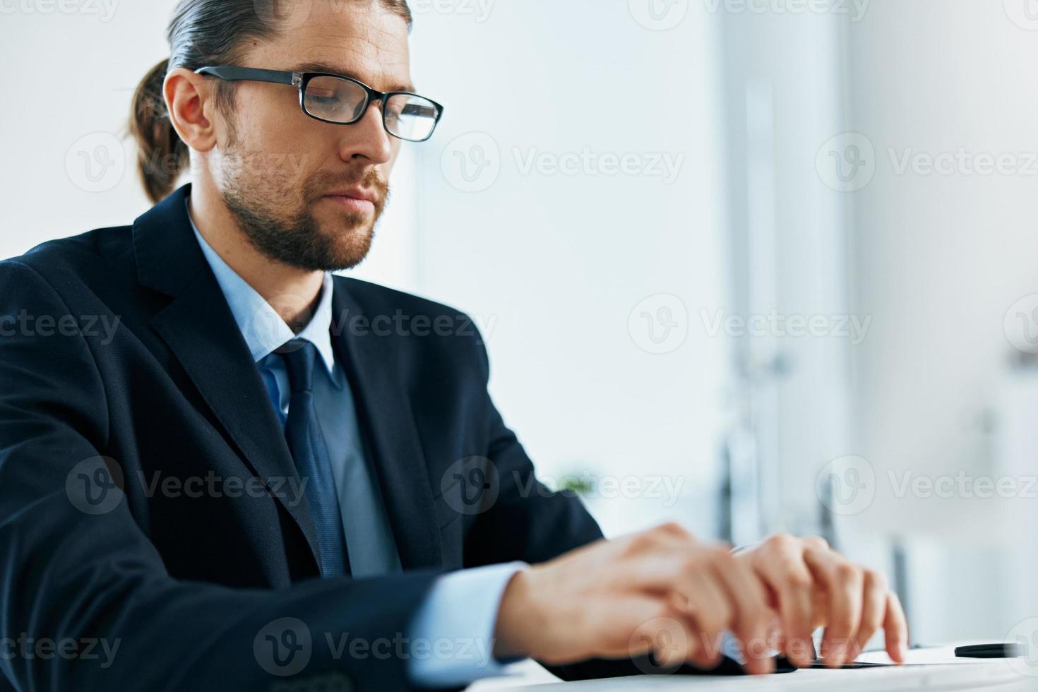 male manager at his desk working in front of a computer photo