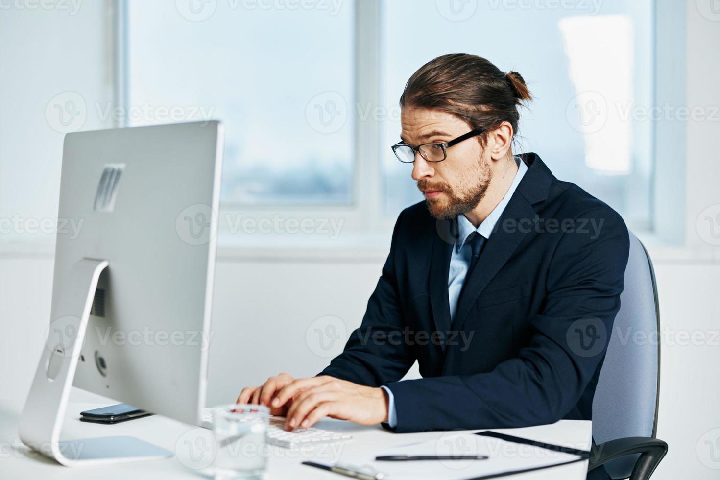 businessman sitting at a desk in front of a computer Lifestyle photo