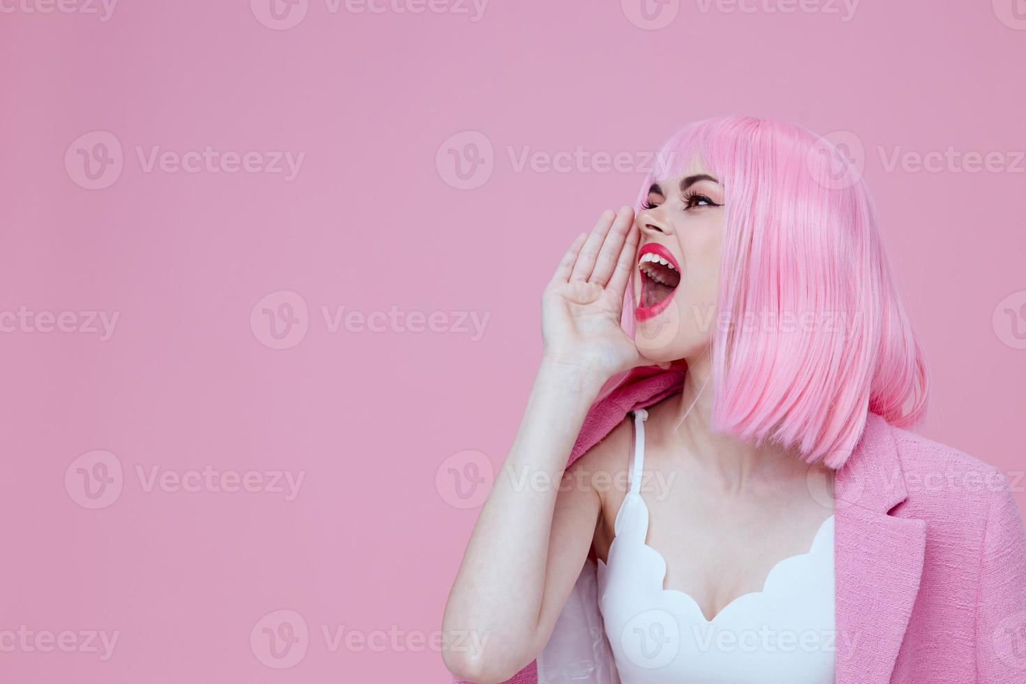 Positive young woman gestures with his hands with a pink jacket Studio Model unaltered photo