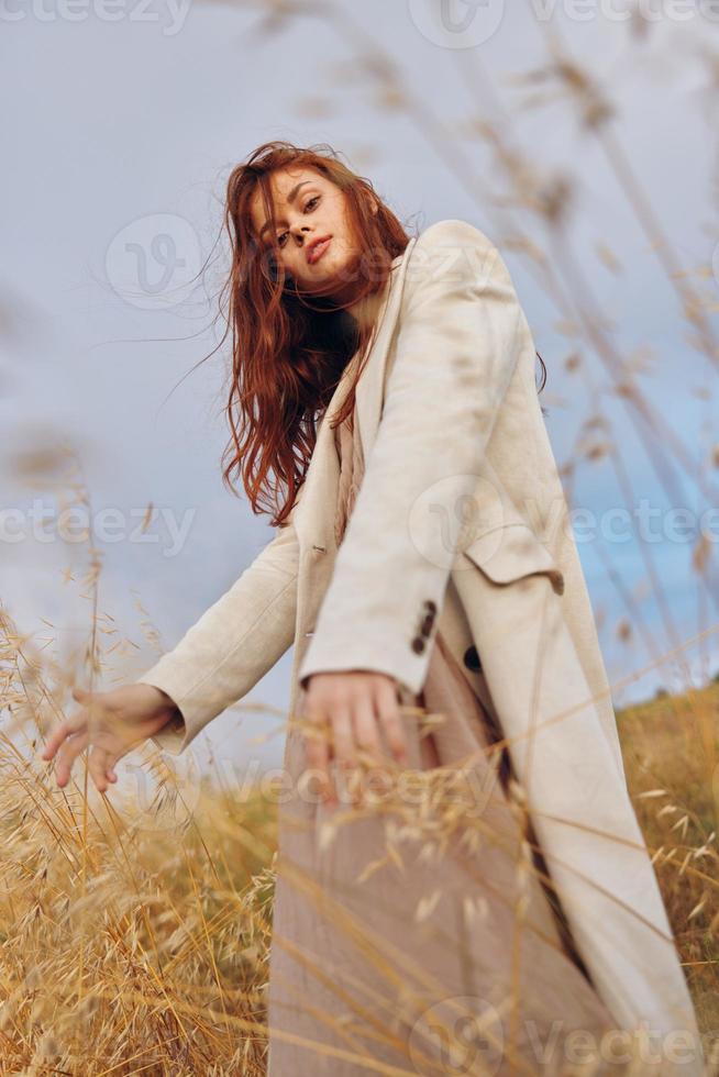 beautiful woman coat outdoors walk sunny day photo