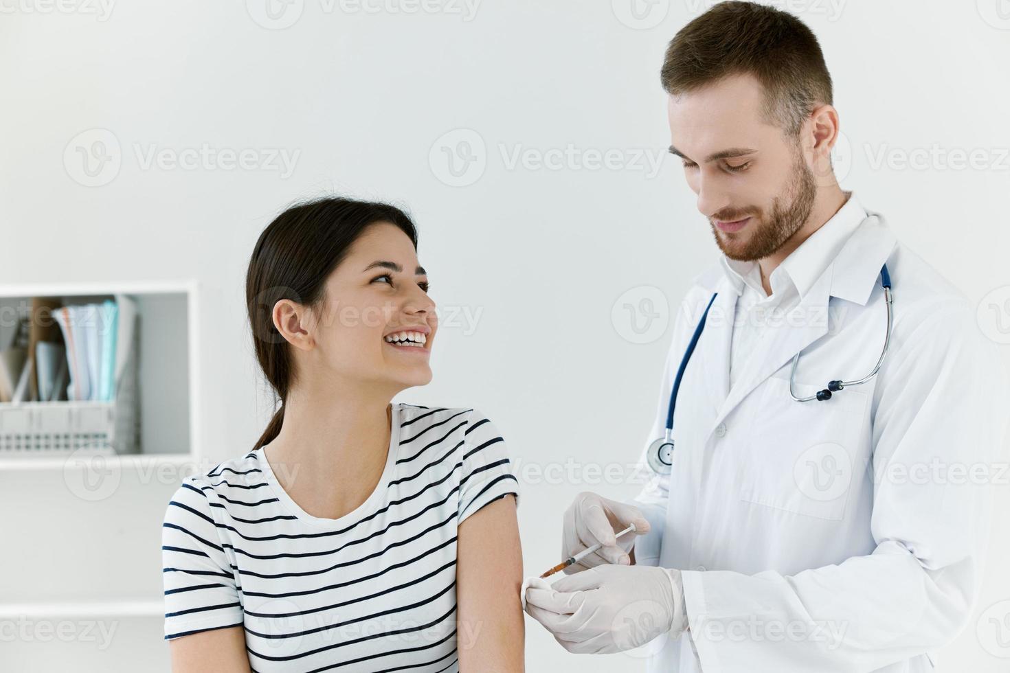 male doctor in a white coat a syringe in the hands of an injection vaccination photo