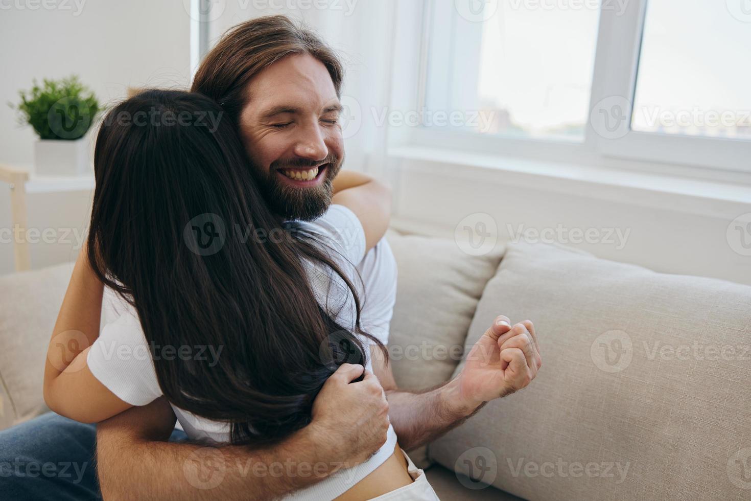 The man hugs the girl and smiles. The joy of using the family and the good psychological state after the quarrel photo