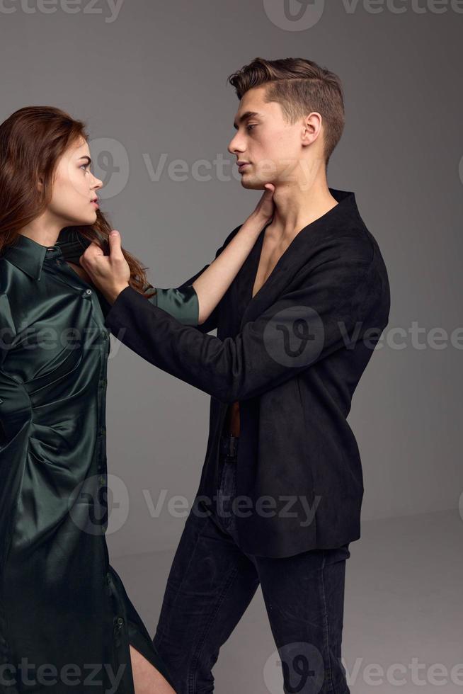 A man in a dark jacket touches the hair on a woman's head and a conflict of distrust photo