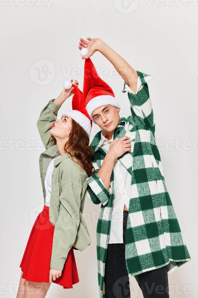 man and woman in new year clothes holiday christmas light background photo