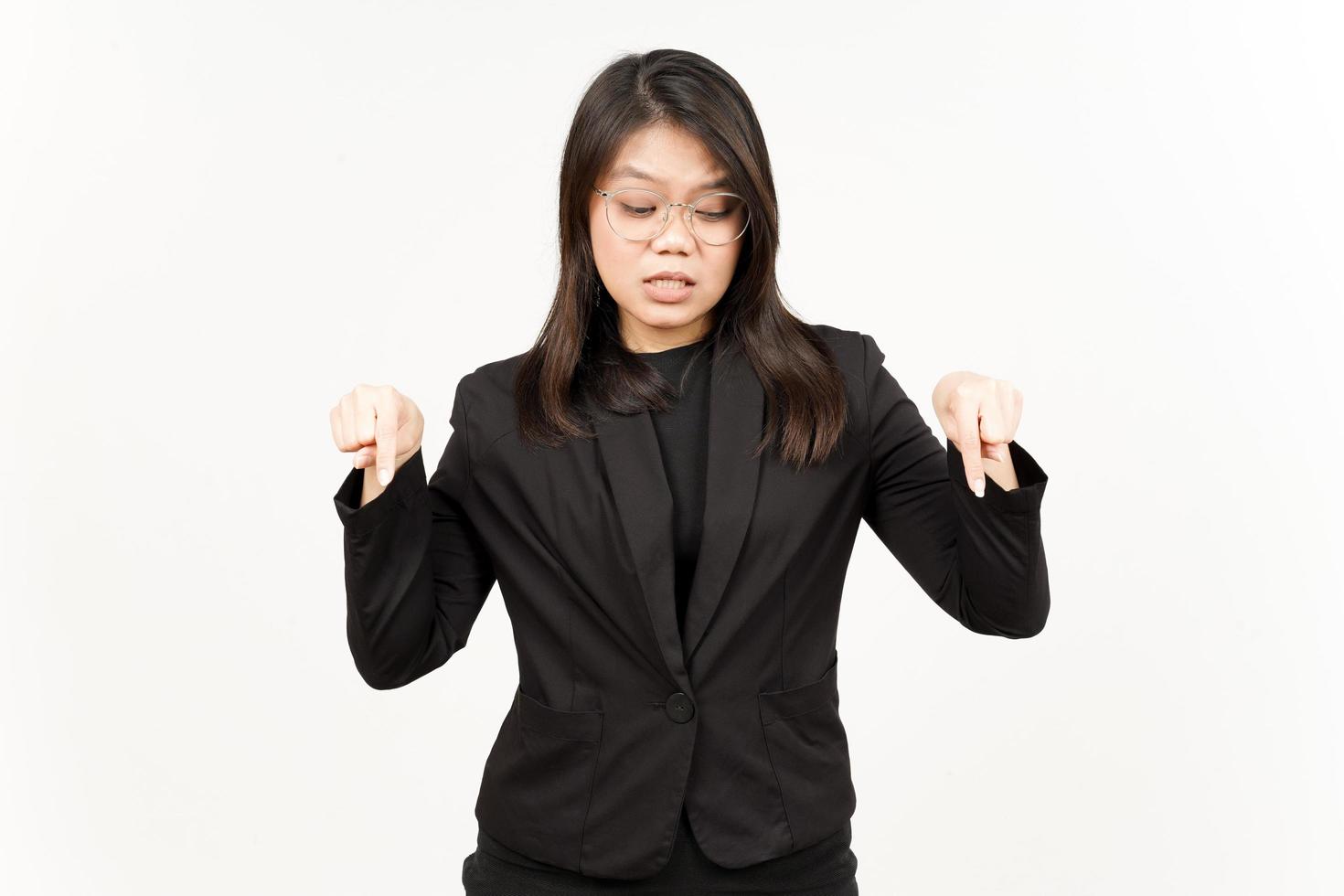 Showing Product and Pointing Down Of Beautiful Asian Woman Wearing Black Blazer Isolated On White photo
