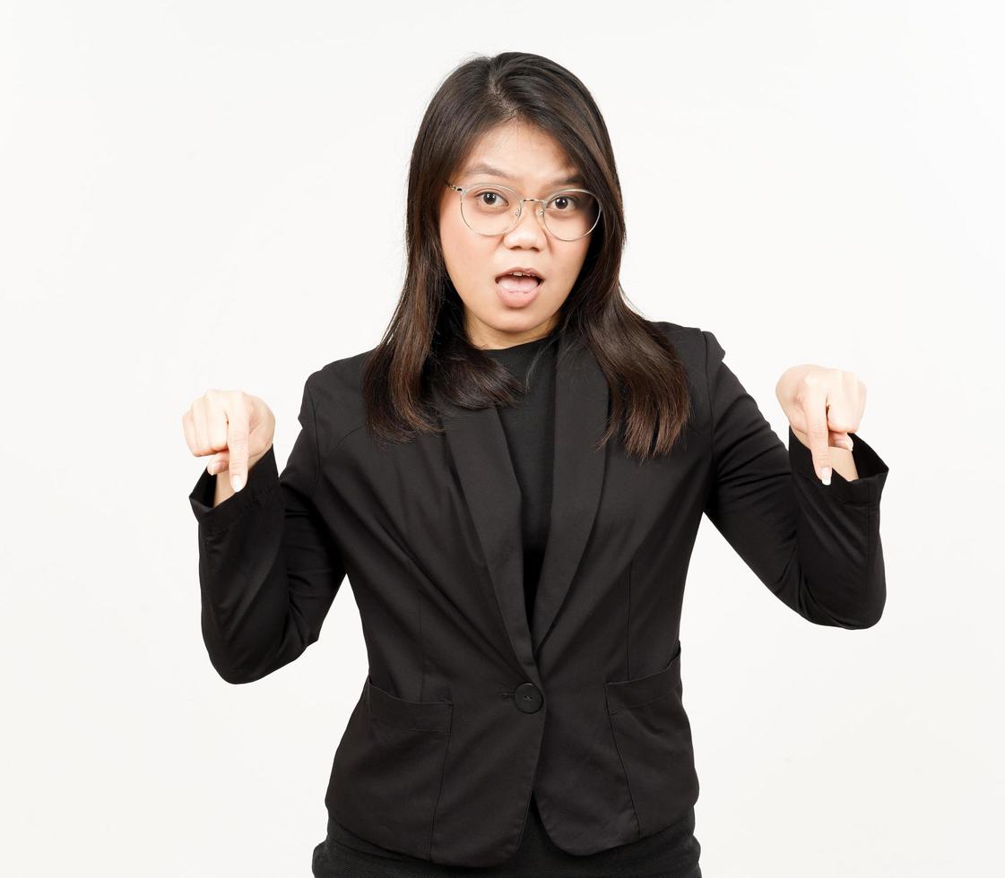 Showing Product and Pointing Down Of Beautiful Asian Woman Wearing Black Blazer Isolated On White photo
