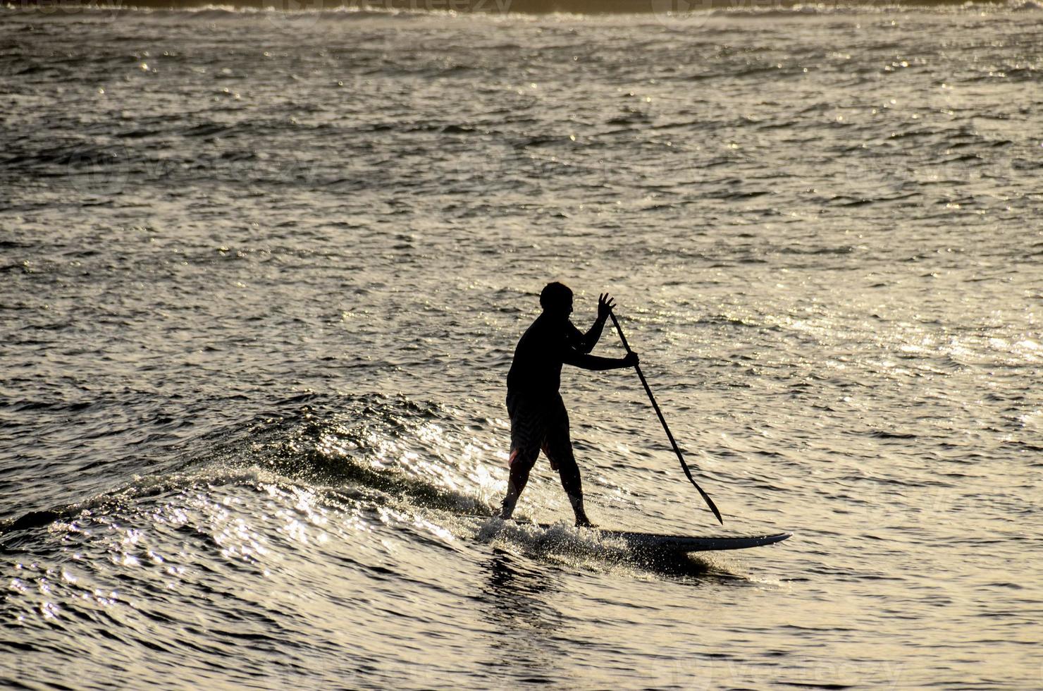 Silhouettes of a surfer photo