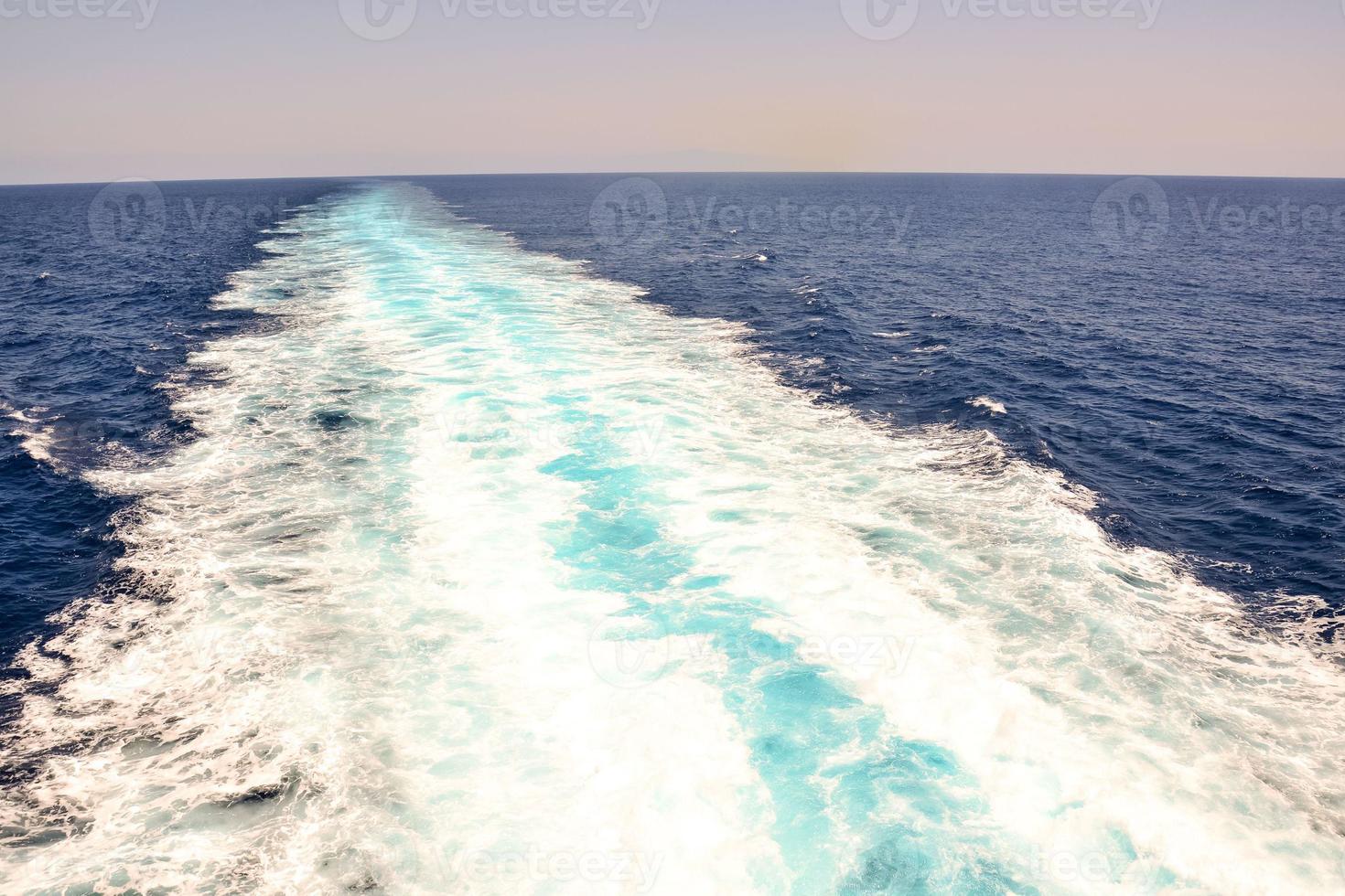 The trace left in the water by a boat photo