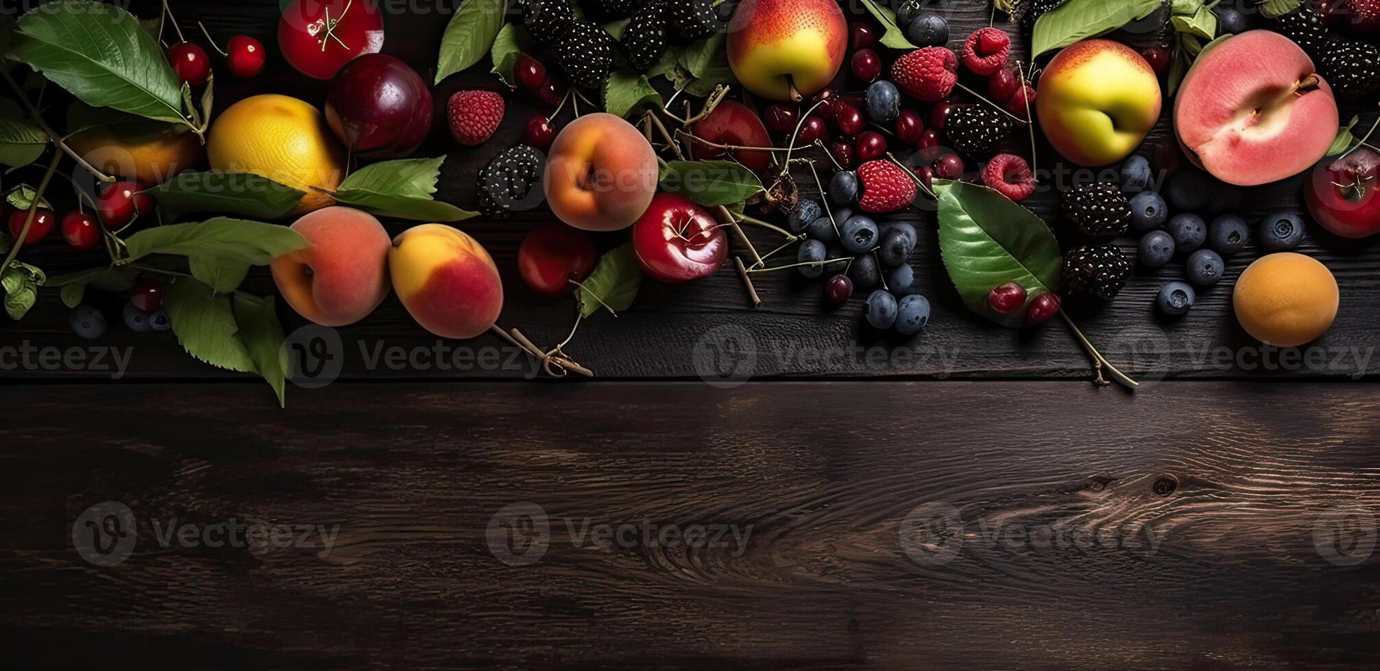 Set of fresh berries and fruits on a dark wodden background. Top view. . photo