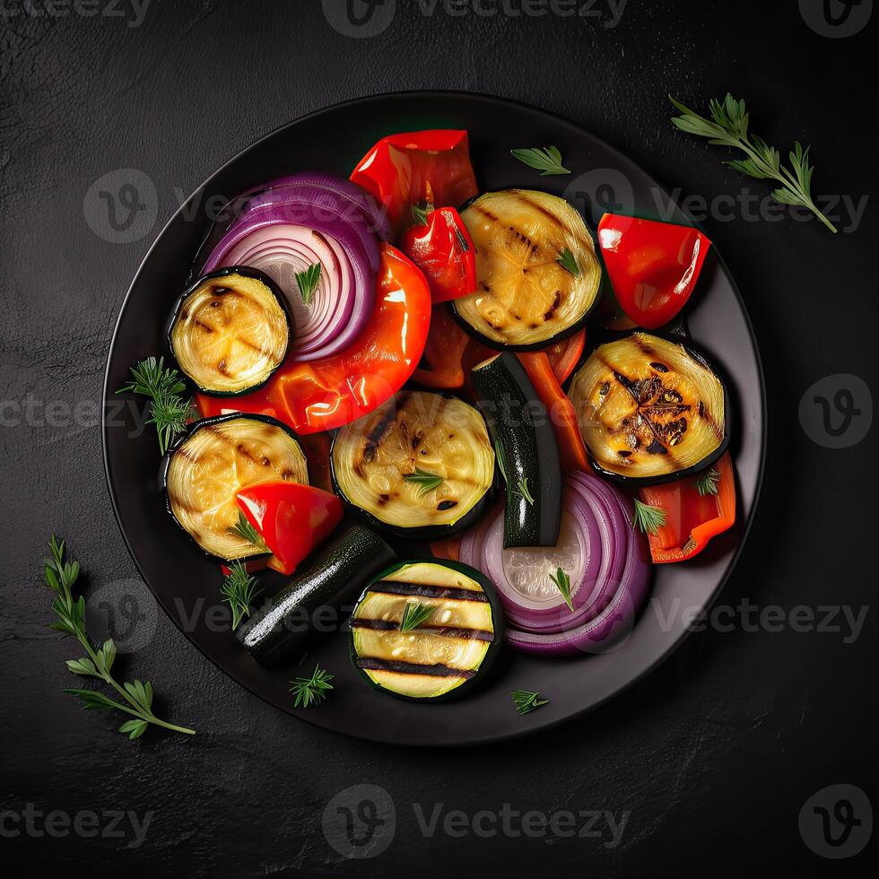 Grilled vegetables, eggplant, bell pepper, zucchini, red onion, tomato on plate. Top view. . photo