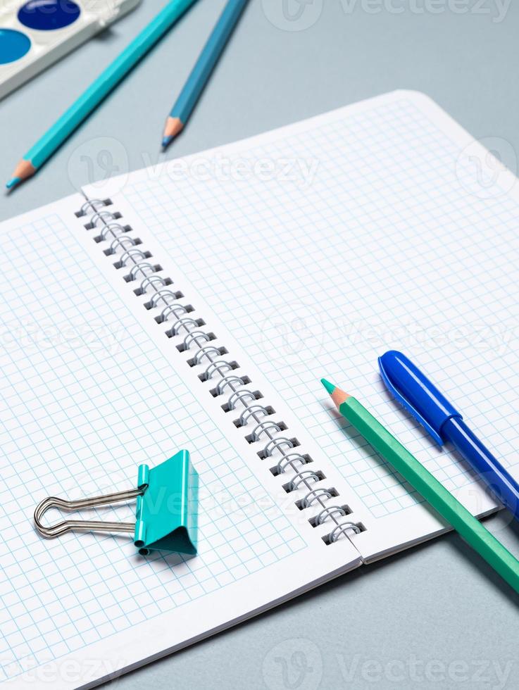 table with open notebook with ballpoint pen, stationery. Business concept planning a day, writing a to-do list, checklist. Top view of workspace photo