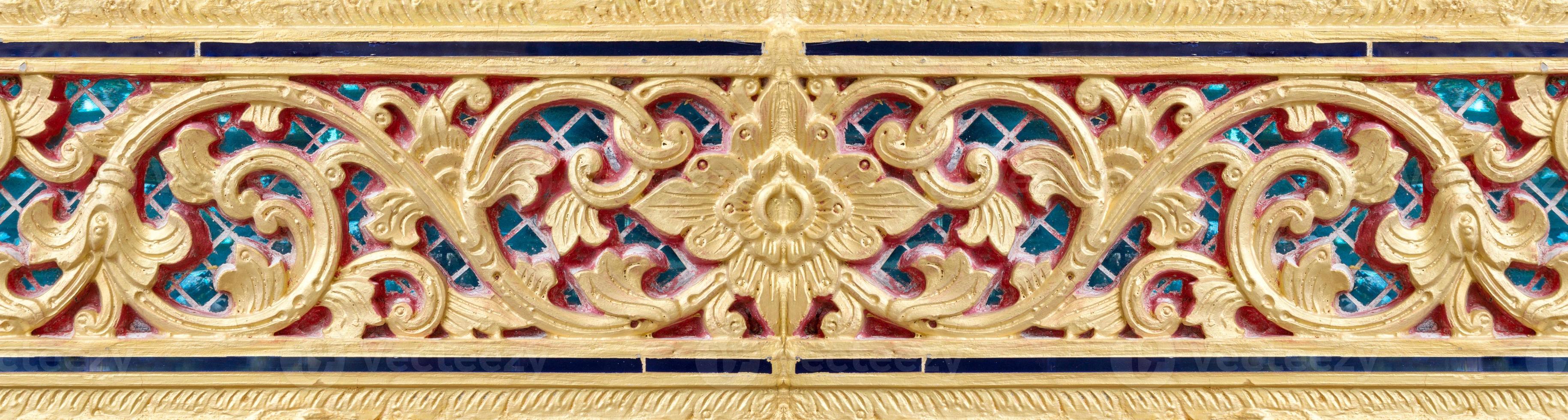 Pattern of gold flower carved on stucco design of native wall, Thai style in temple photo
