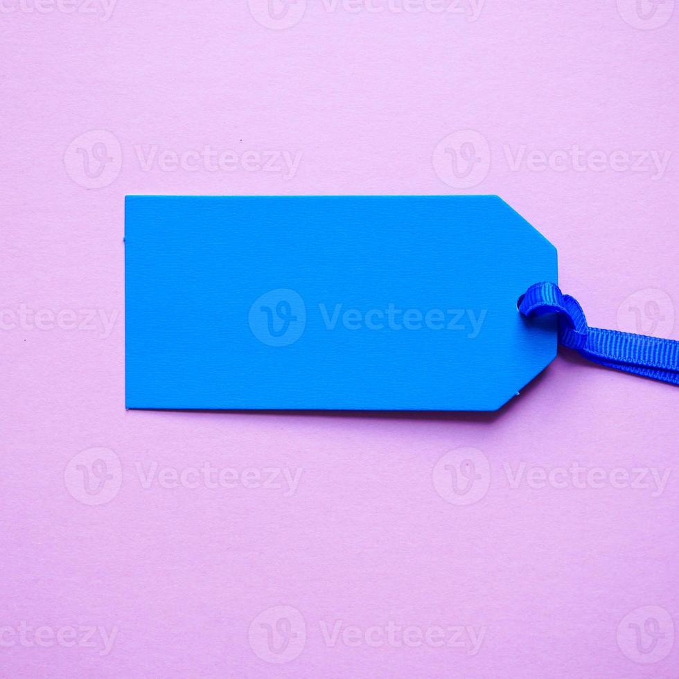 blue price tag on the pink background photo