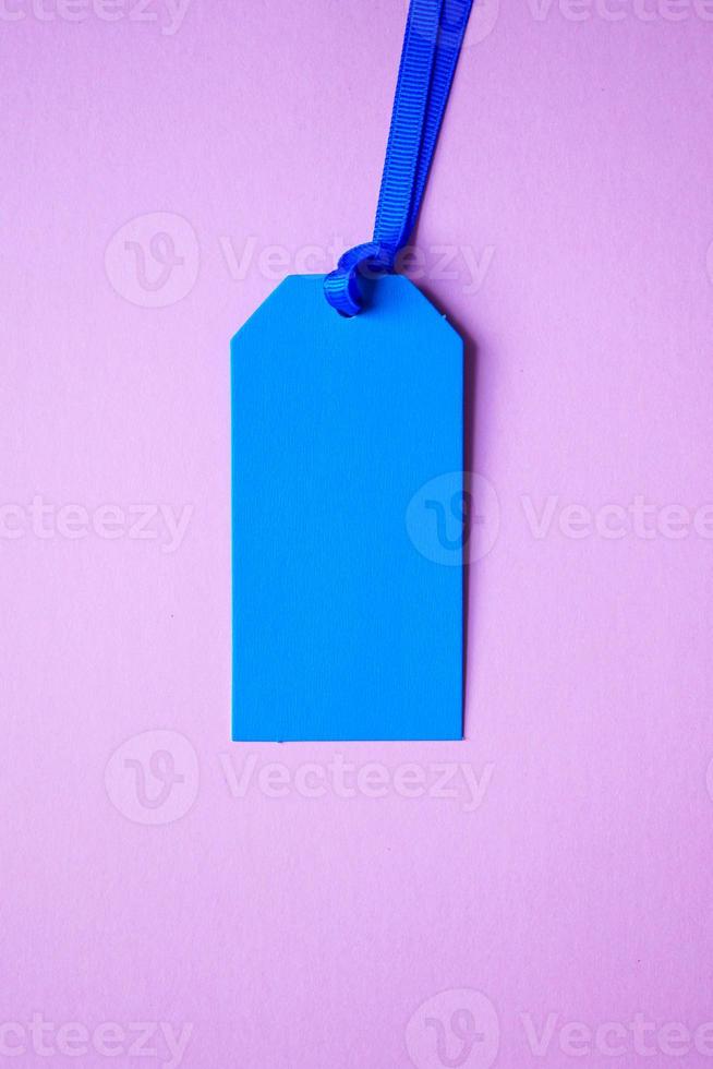 blue price tag on the pink background photo