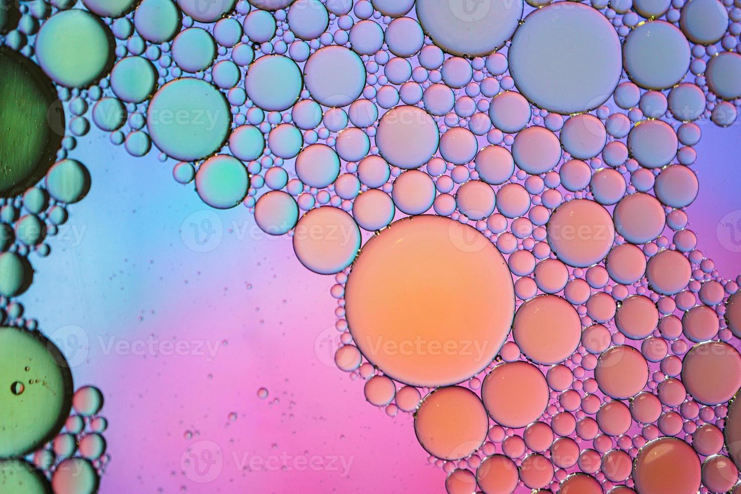 multi colored oil circles on the water, colorful background photo