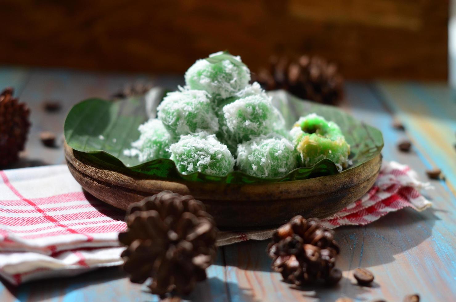 Klepon or kelepon is one of Indonesia's traditional cakes made from glutinous rice flour which is shaped like small balls and filled with brown sugar and then boiled photo