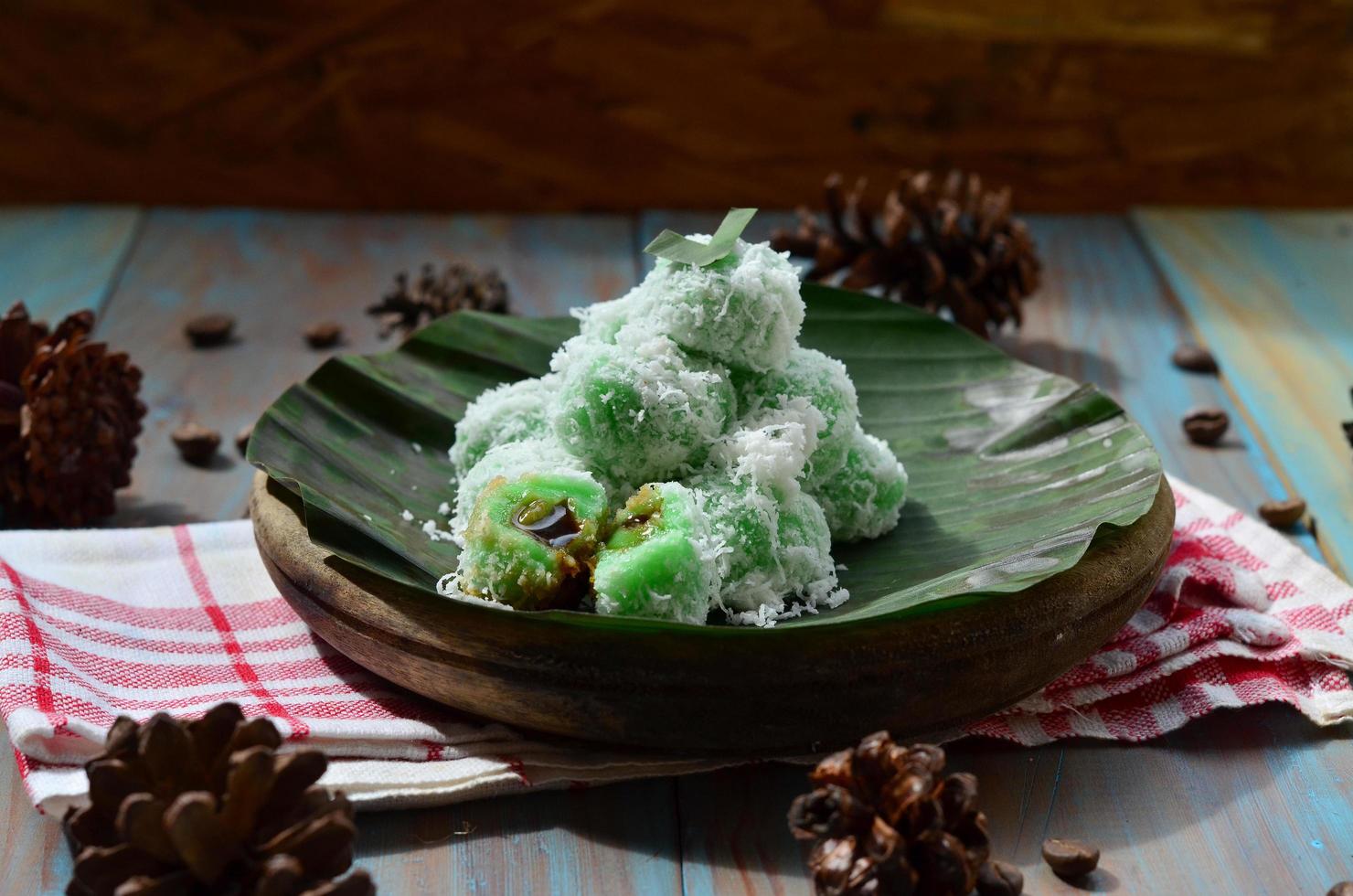 Klepon or kelepon is one of Indonesia's traditional cakes made from glutinous rice flour which is shaped like small balls and filled with brown sugar and then boiled photo