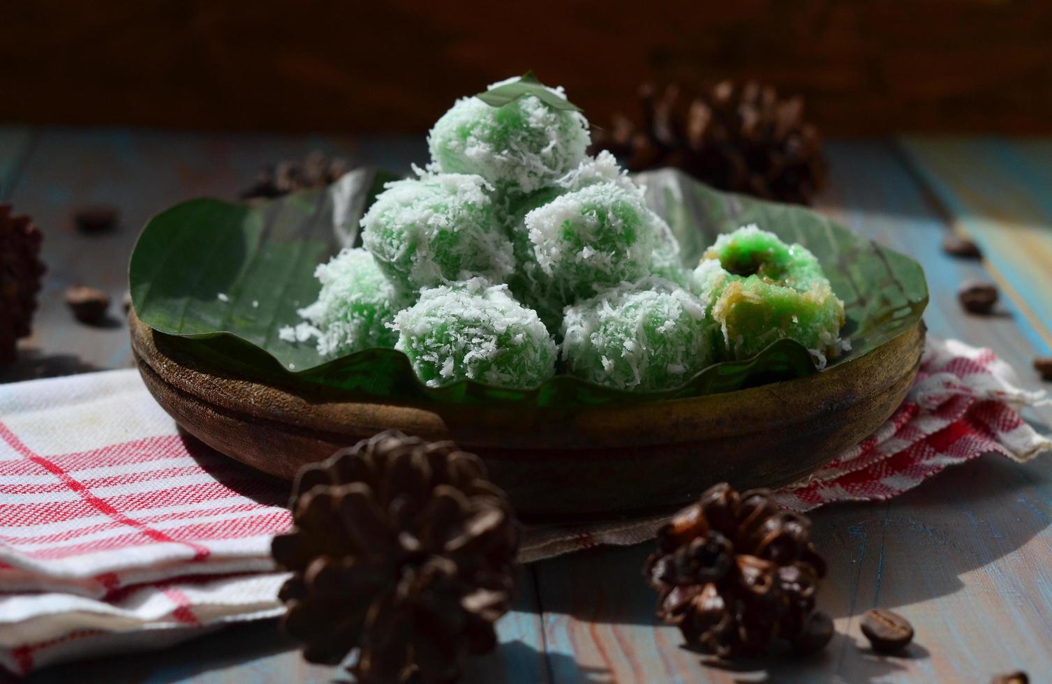 Klepon or kelepon is one of Indonesia's traditional cakes made from glutinous rice flour which is shaped like small balls and filled with brown sugar and then boiled photo