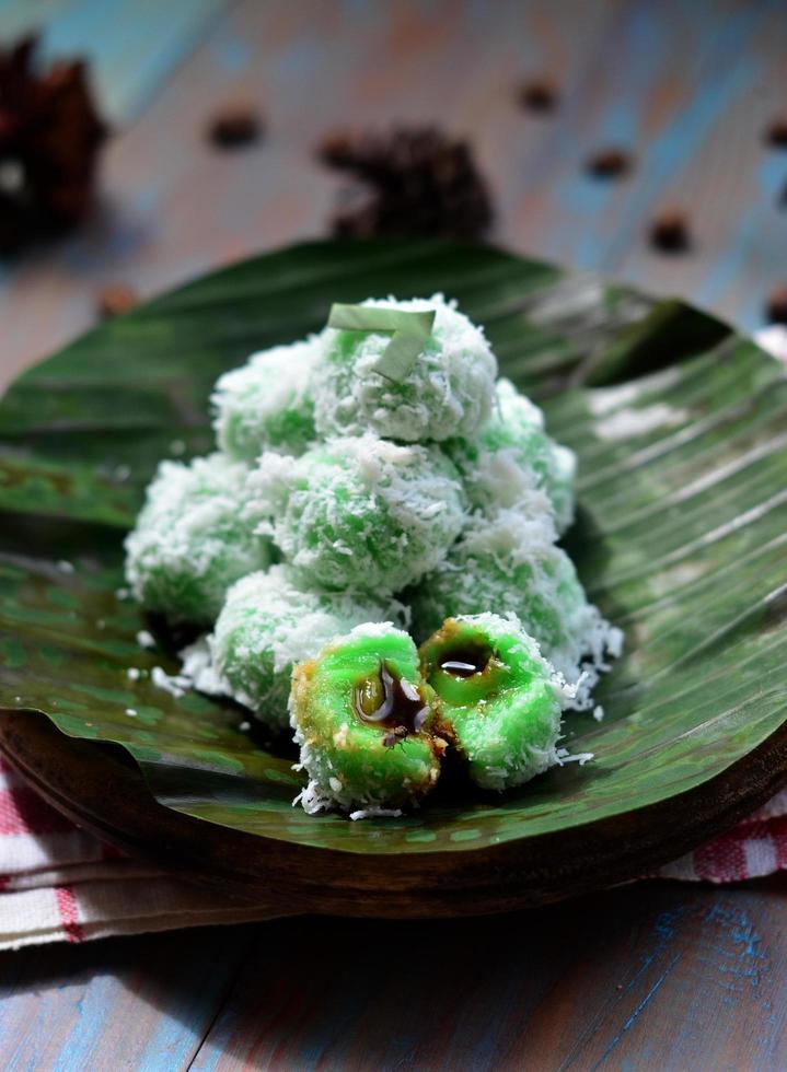 Klepon or kelepon is one of Indonesia's traditional cakes made from glutinous rice flour which is shaped like small balls and filled with brown sugar and then boiled photo