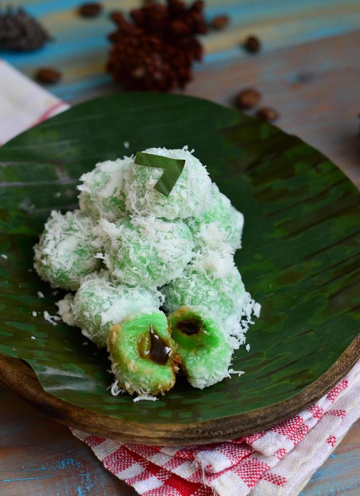 Klepon or kelepon is one of Indonesia's traditional cakes made from glutinous rice flour which is shaped like small balls and filled with brown sugar and then boiled photo