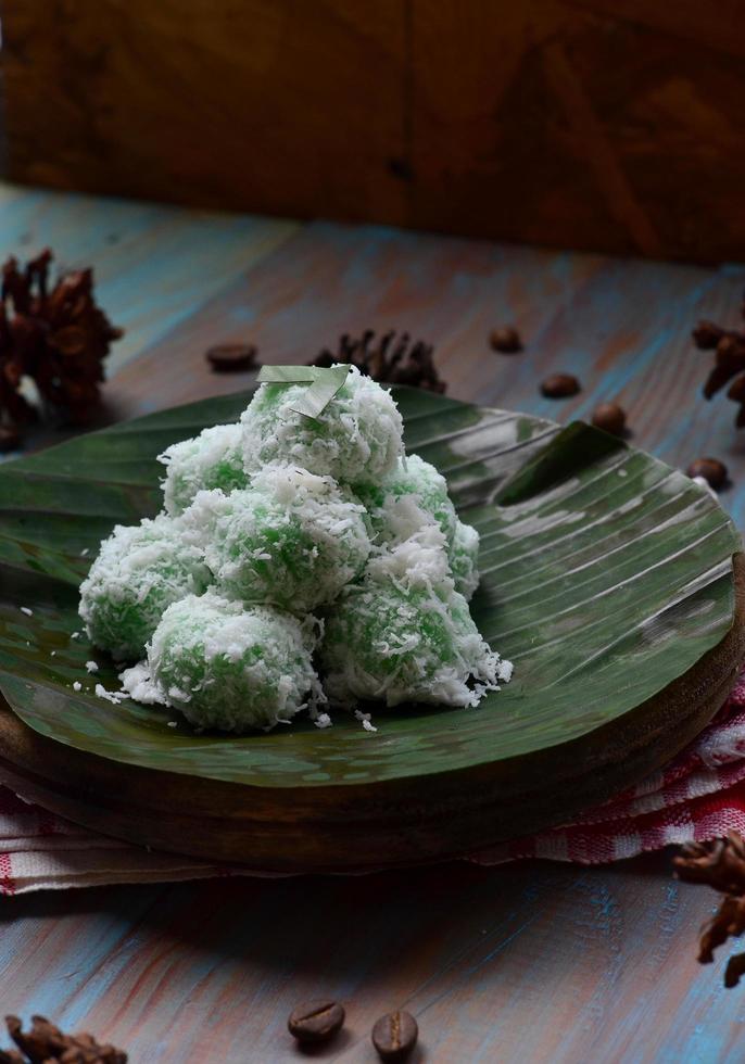 Klepon or kelepon is one of Indonesia's traditional cakes made from glutinous rice flour which is shaped like small balls and filled with brown sugar and then boiled photo