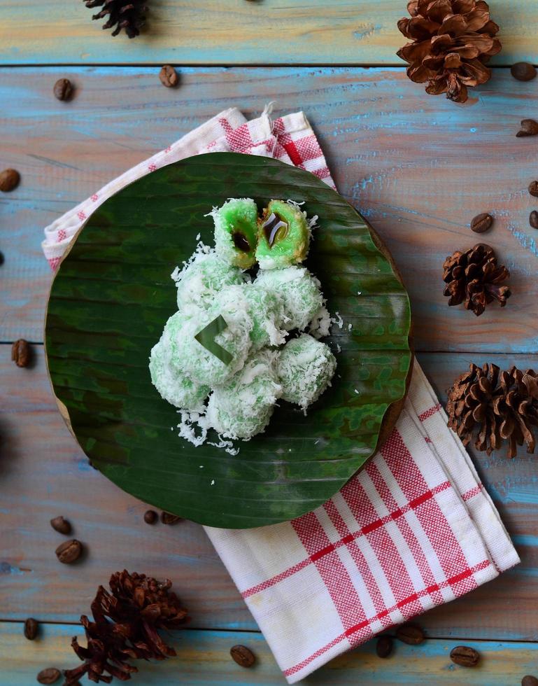 Klepon or kelepon is one of Indonesia's traditional cakes made from glutinous rice flour which is shaped like small balls and filled with brown sugar and then boiled photo