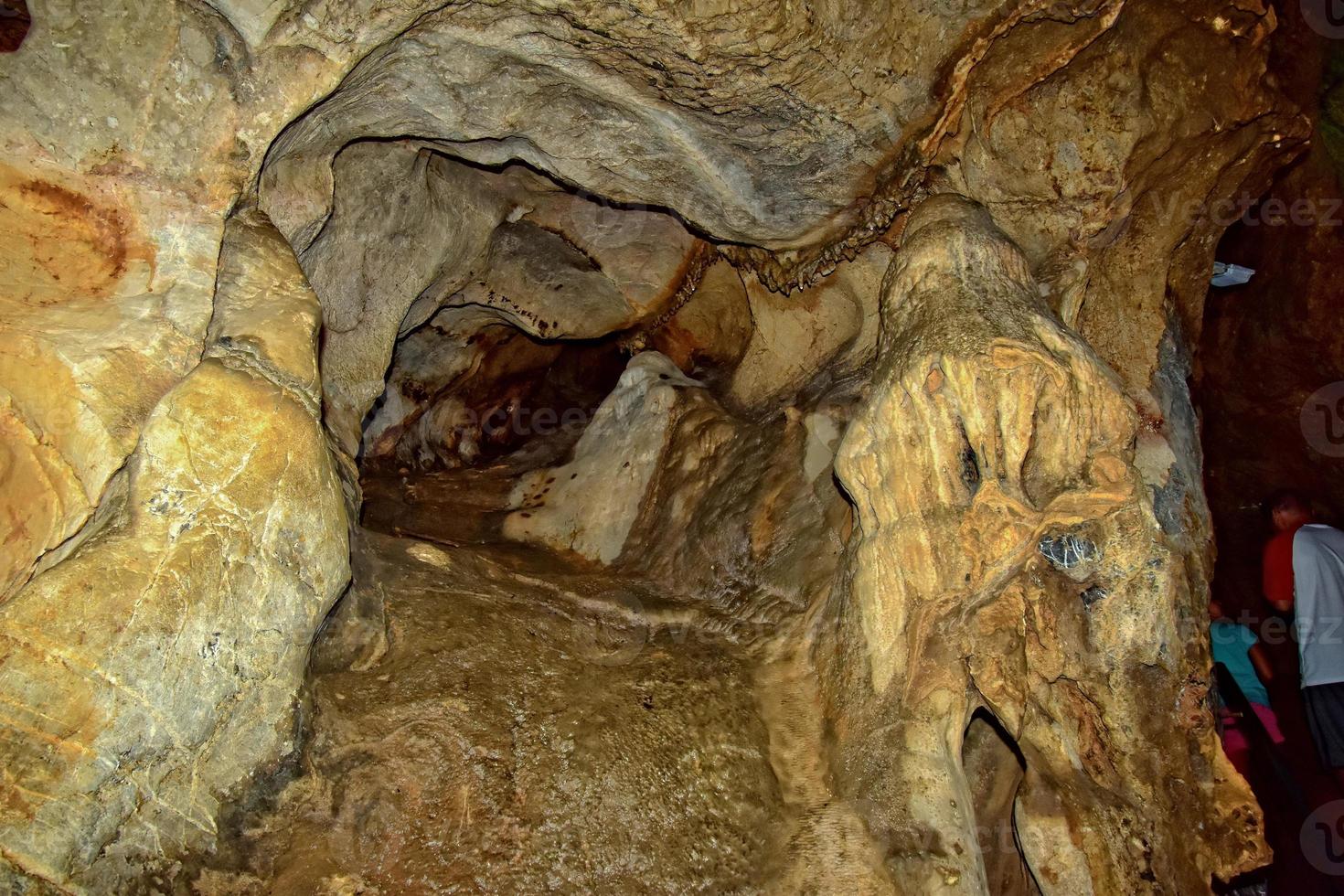 interesting original cave in the Turkish mountains with stalactites and stalagmites creating the background photo