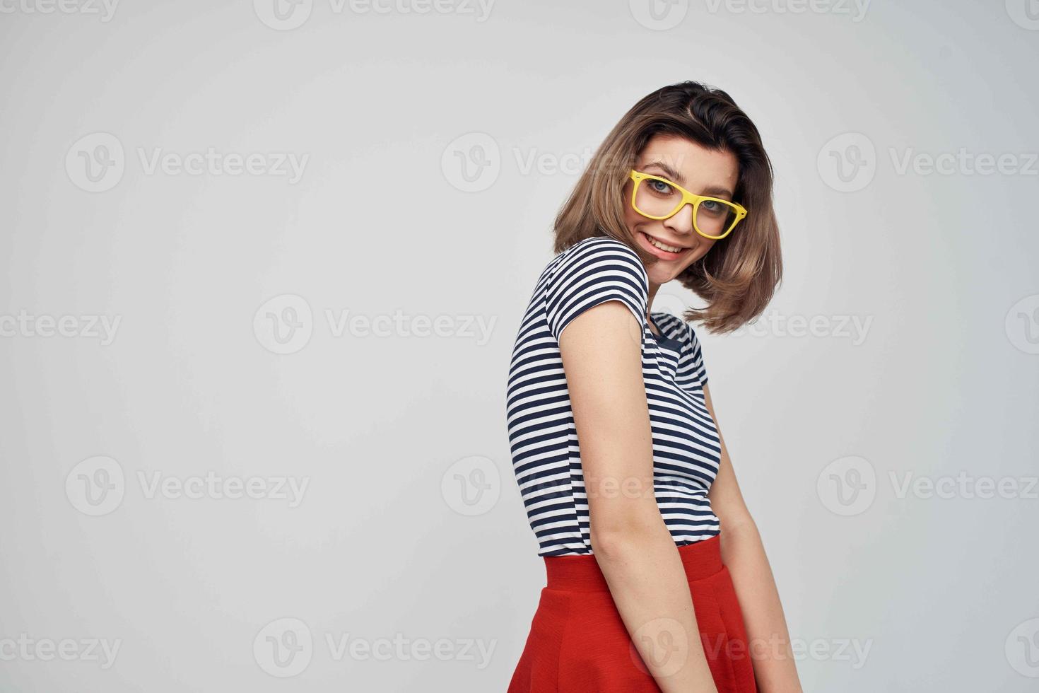 woman in striped t-shirt fashion glasses studio posing photo