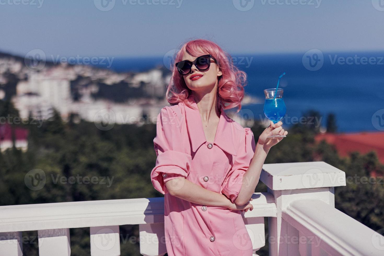 Young female in sunglasses outdoors on the terrace cocktail relaxing Relaxation concept photo
