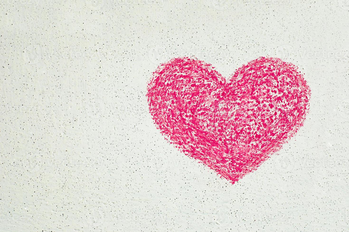 Pink heart drawn with chalk on white wall, copy space photo