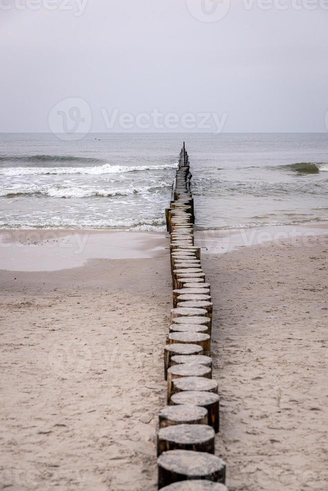 seaside landscape of the baltic sea on a calm day with a wooden breakwater photo