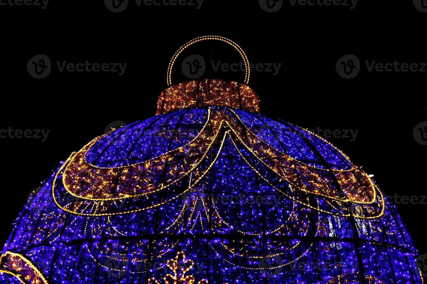 big christmas bauble decoration in alicante street on black night background photo