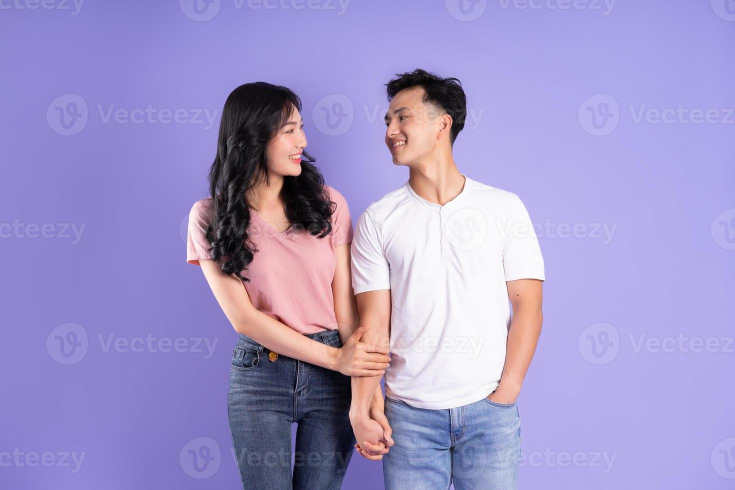 image of asian couple posing on purple background photo