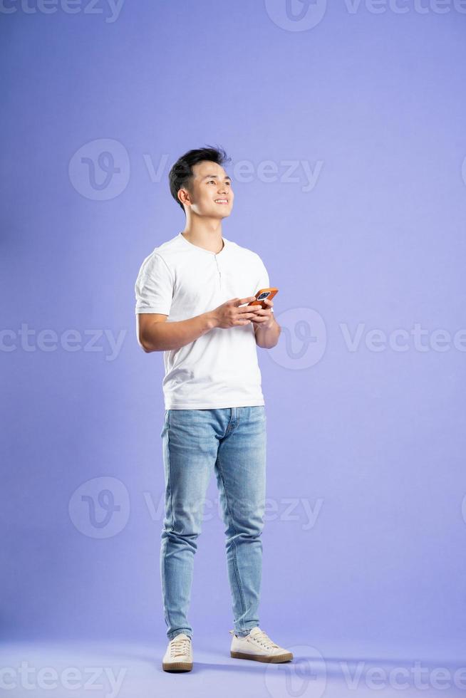image of asian boy posing on purple background photo