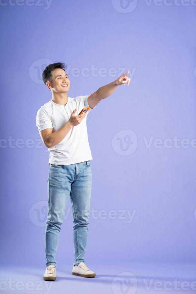 image of asian boy posing on purple background photo