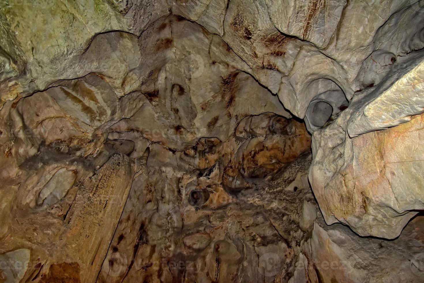 interesting original cave in the Turkish mountains with stalactites and stalagmites creating the background photo