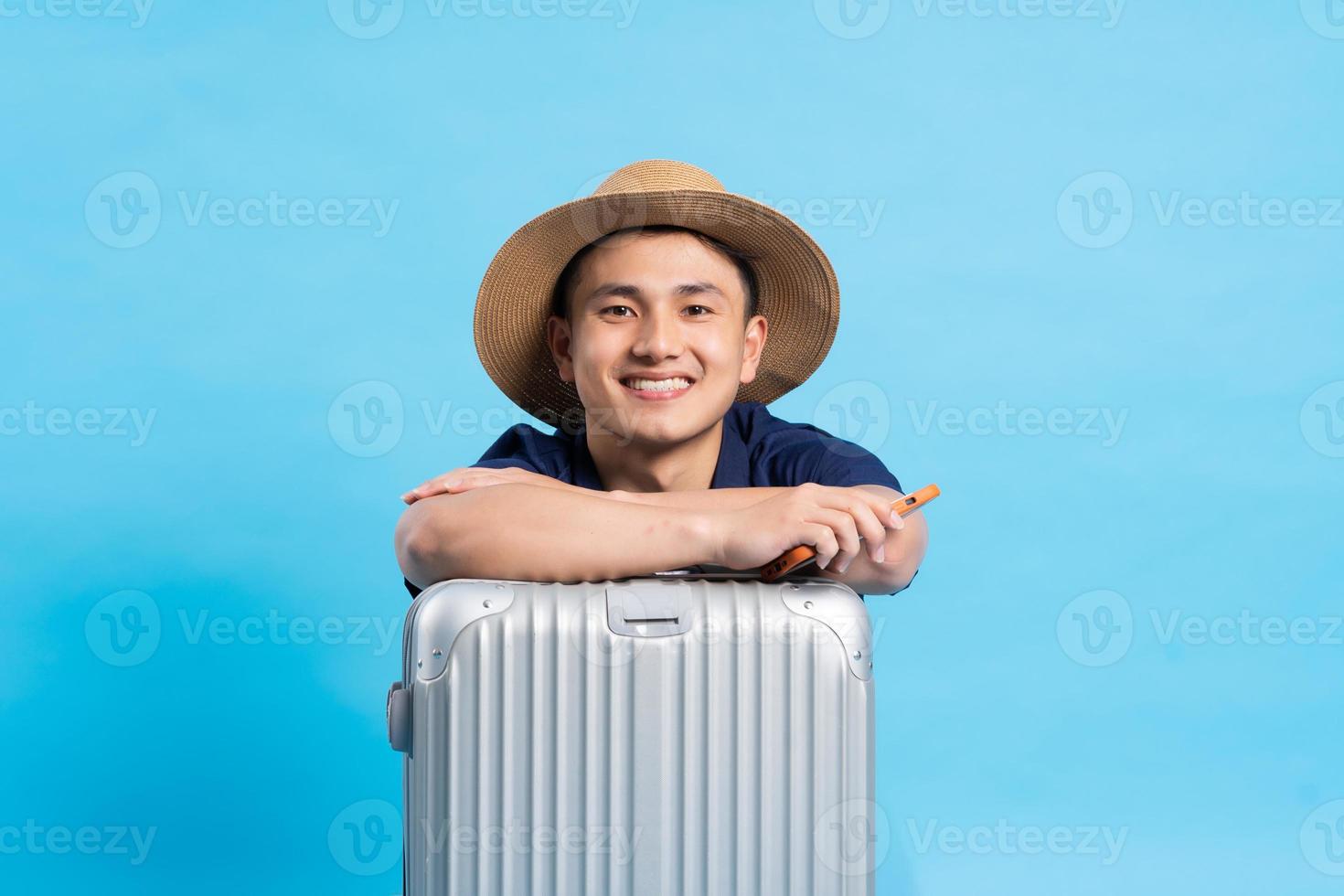 travel asian man portrait, isolated on blue background photo