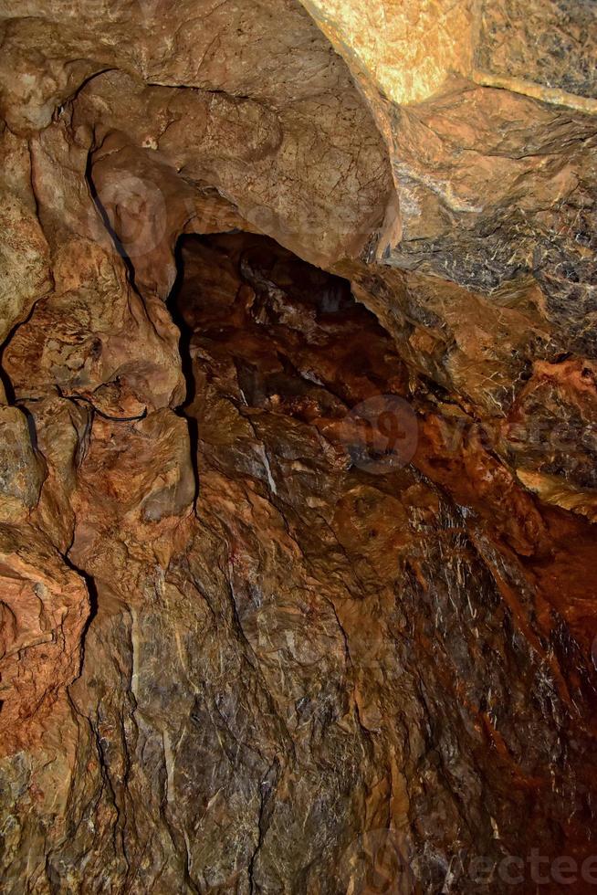 interesting original cave in the Turkish mountains with stalactites and stalagmites creating the background photo