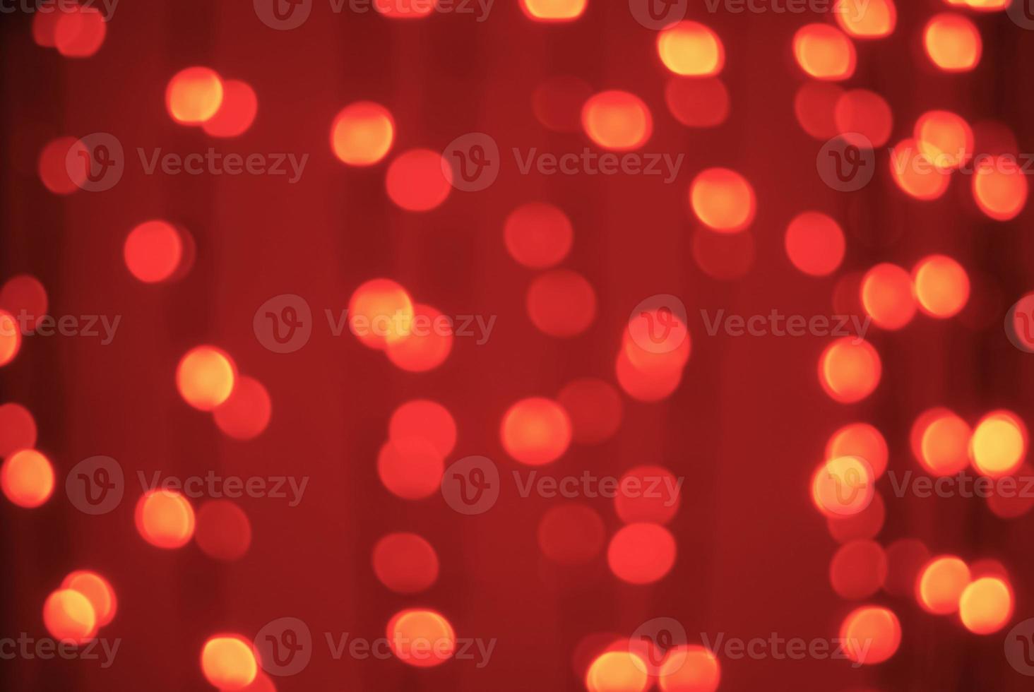 Red-orange trendy festive background of blurry Christmas lights photo