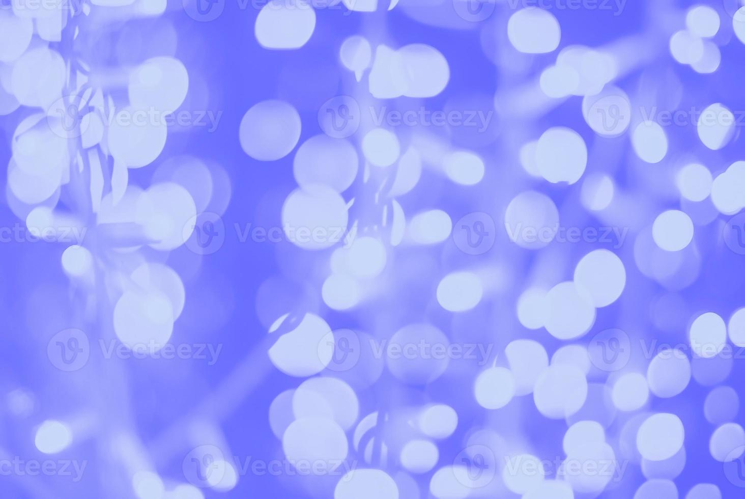 blue purple white blurred lights of diode garland, blurry full frame background photo