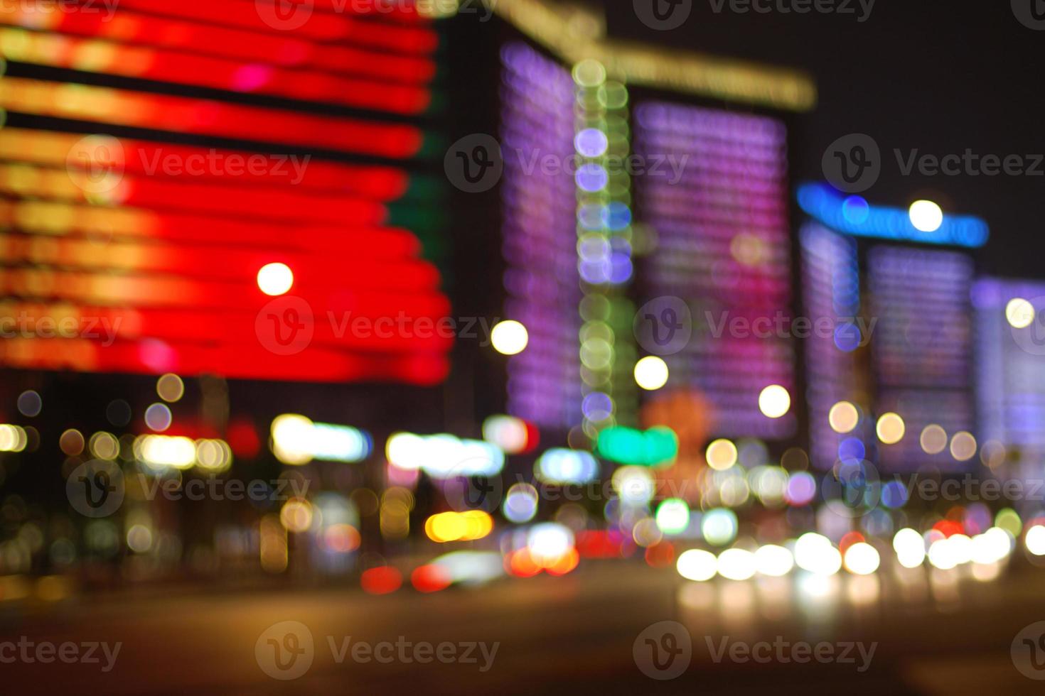 Colorful bright city lights at night, urban bokeh background photo