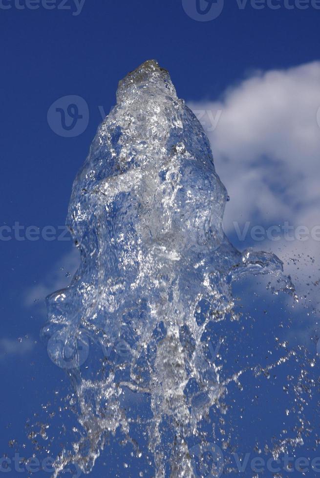 spurt of water over cloudy sky photo