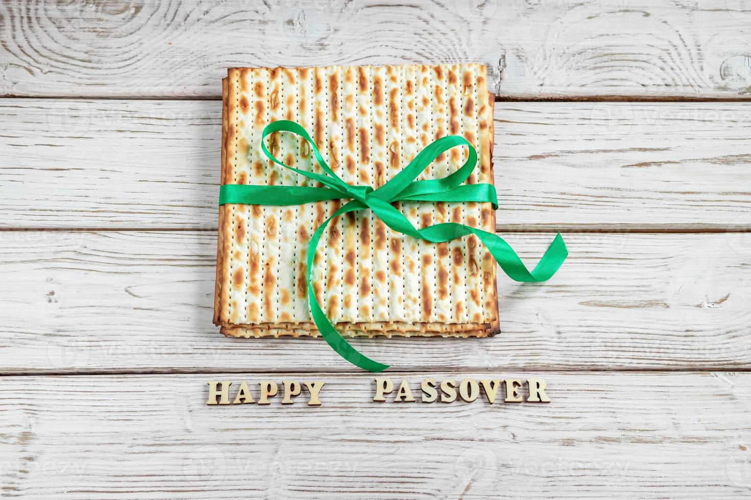 Happy Passover. Matzah on a white wooden background. Traditional Jewish regilious holiday of Pesach. Matzo bread. photo