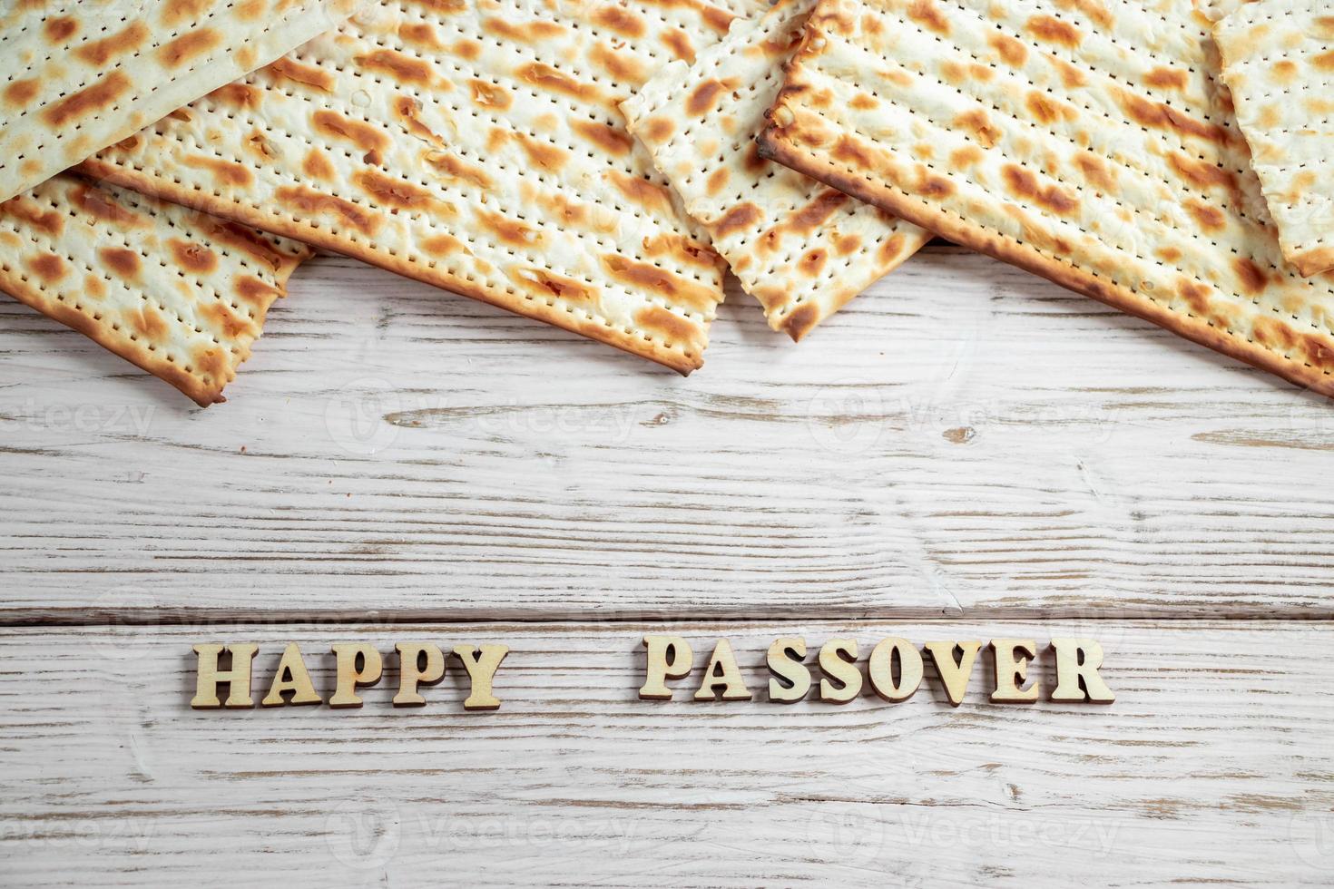 Happy Passover. Matzah on a white wooden background. Traditional Jewish regilious holiday of Pesach. Matzo bread. photo