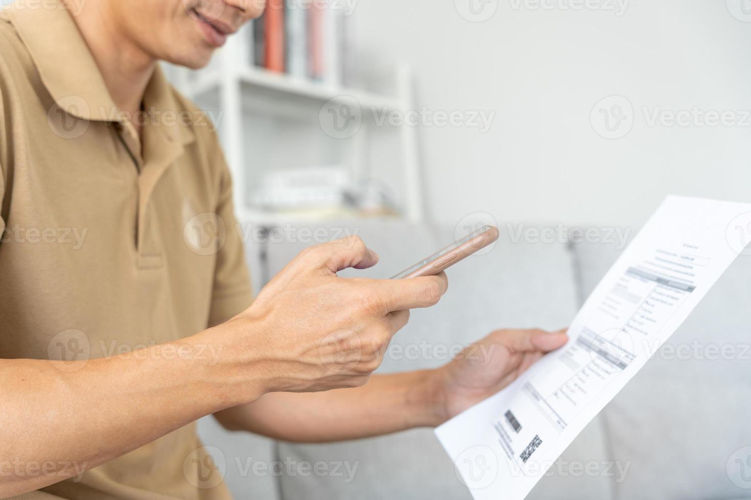man use phone to scan barcode or QR codes to pay credit card bill after receiving document invoice online. payment, receive, paying electricity, digital payments without money, technology, scanning photo