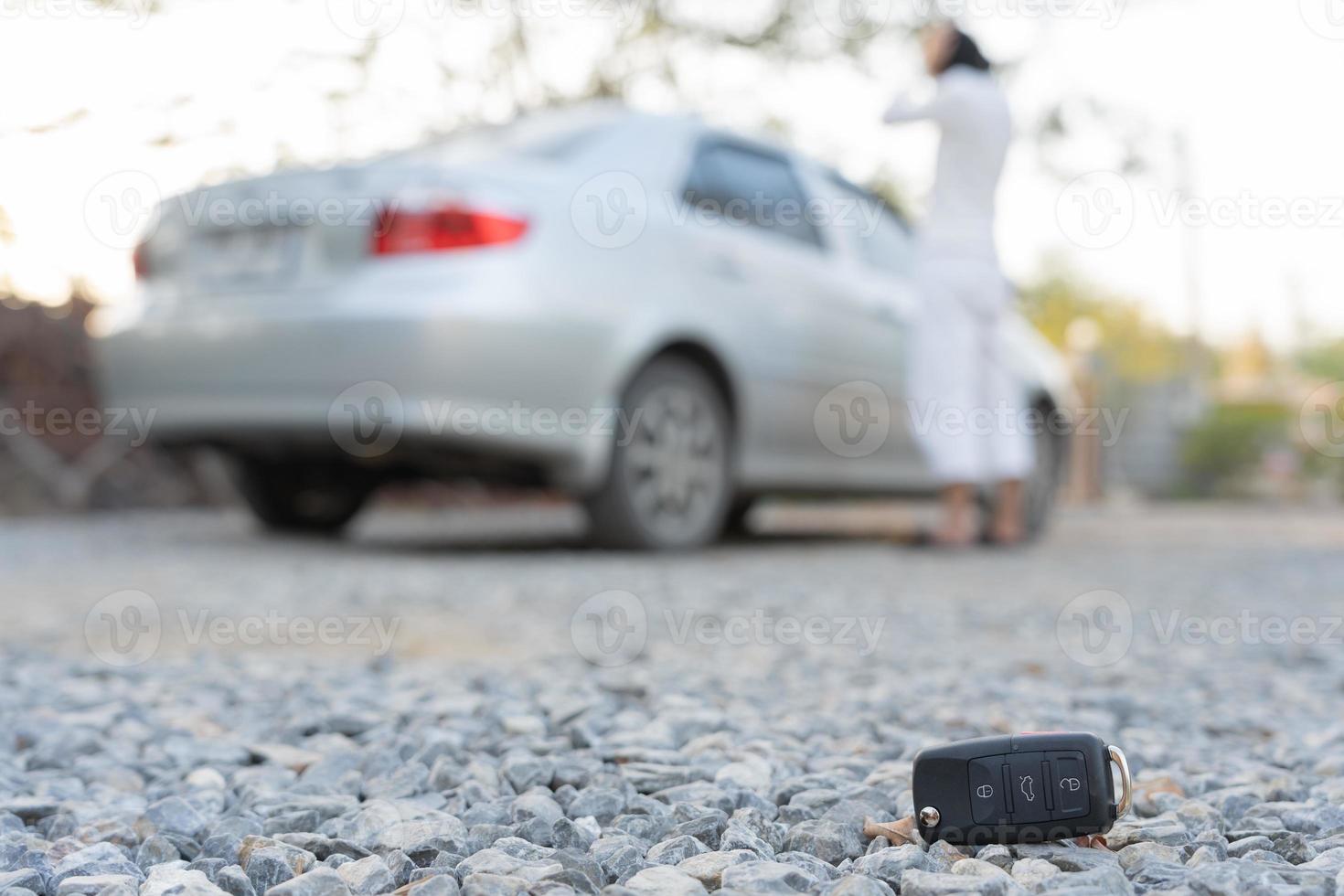 Lost car keys on the ground, Car keys dropped on the floor or fall lying on the street home front . Walking Away From Lost Car Key, can not transport, express, rush time, wast time, emergency photo
